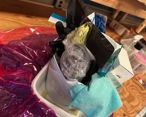 Messy collection of household cleaning tools